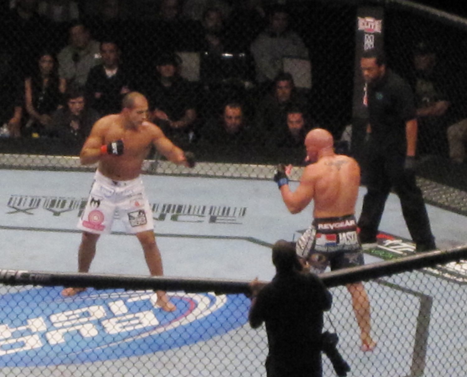 Mixed martial arts fighters competing inside a cage