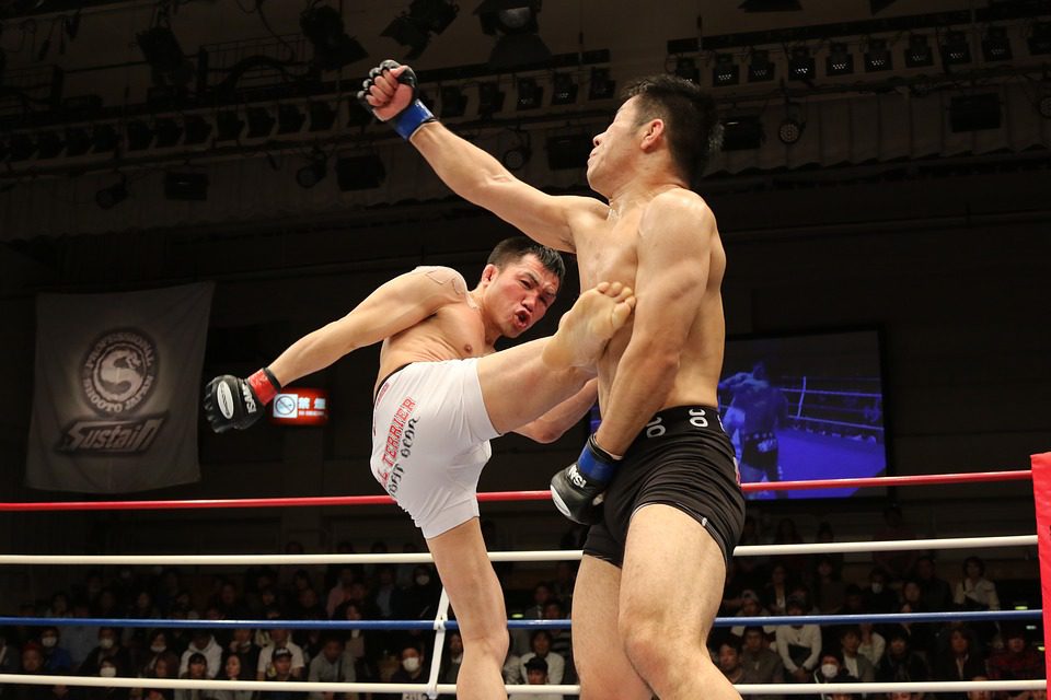 Mixed martial arts striking exchange near the cage